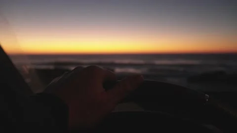 POV of a driver behind the wheel of a caravan at sunset over the ocean Stock Footage 231476899