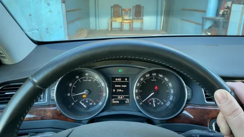 POV driver behind the wheel reversing car out of garage. Stock Footage 119122245