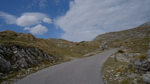 POV from the drivers perspective through a winding mountain road Vídeo Stock 98336562