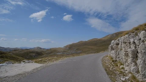 POV from the drivers perspective through a winding mountain road 스톡 동영상 98401218