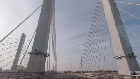 POV Driving Across Modern Cable Stayed Bridge with Tall White Pillars Stockbeeldmateriaal 334862394