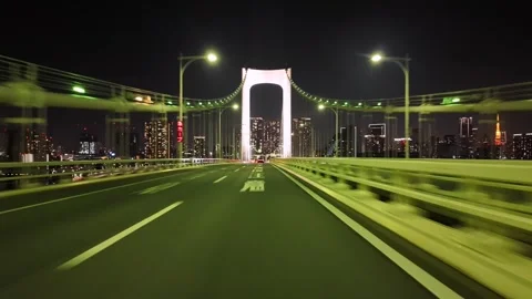 POV Driving across Rainbow Bridge on Metropolitan Expressway at Night Stock Footage 334677108