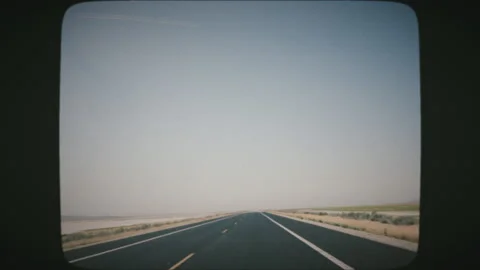 POV Driving along wide empty meadow on a sunny day. VINTAGE FILM. Stock Footage 136731042