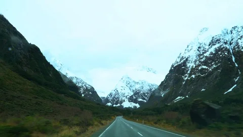 POV Driving between the mountains towards Milford Sound in New Zealand Stock Footage 95391380