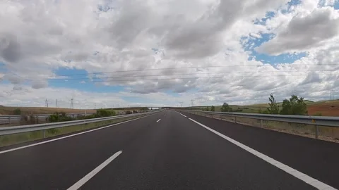 POV driving car on empty highway road through the fields during sunny day. Spain Stock Footage 203840160
