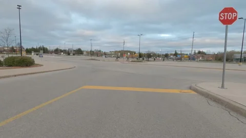 POV driving city streets empty and shopping mall in COVID 19 pandemic lockdown Видео 153061041