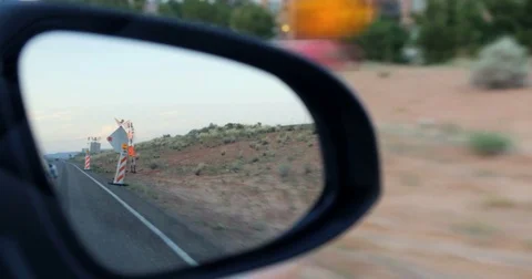 POV driving by construction signs desert side car rear view mirror reflection 4K Stock Footage 78053179