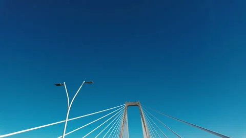 POV driving cross a large cable stayed bridge on a sunny day. Tall support Stock Footage 321445751