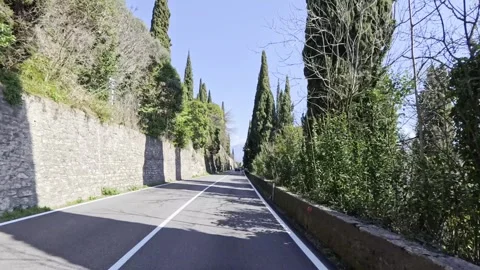 POV Driving Cypress Trees Ancient Stone Wall Lake Garda Italy 4K HDR Stock Footage 331205804