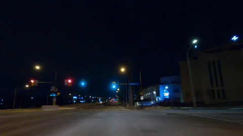 POV driving on dark empty city streets during COVID 19 pandemic lockdown Stock Footage 147900749