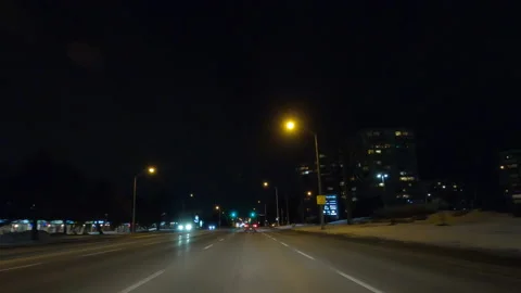 POV driving on dark empty city streets during COVID virus pandemic lock down Stock Footage 147907971