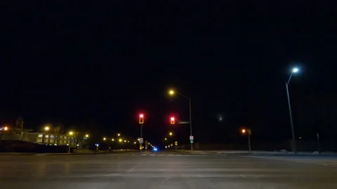 POV driving on dark empty city streets during COVID virus pandemic lock down Видео 147919634