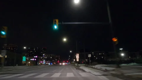 POV driving on dark empty city streets during COVID virus pandemic lock down Stock Footage 147926734