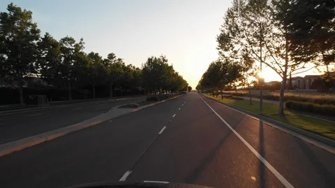 POV: Driving down the empty avenue near suburban neighborhood on sunny morning. Stock Footage 97081545