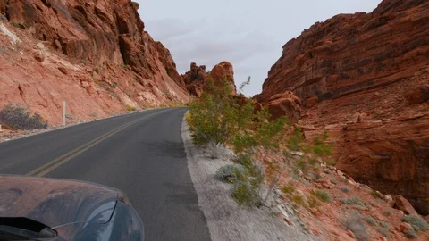 POV driving down road through desert  canyon on windy day Stock Footage 102900634