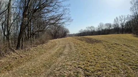 POV - Driving on the edge of an empty field in early spring in the Video stock 275217820