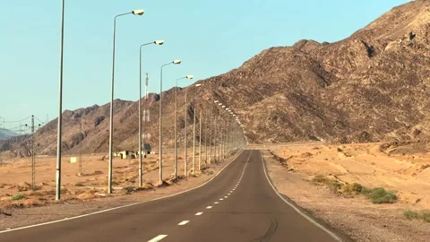 POV driving on empty desert asphalt road with mountains and street lamps Stock Footage 341837797