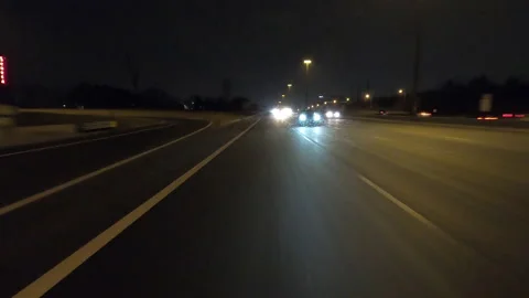 POV driving fast reverse shot at night on dark highway with car traffic Vídeo Stock 146925876