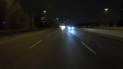 POV driving fast reverse shot at night on dark highway with car traffic Vídeo Stock 146926352
