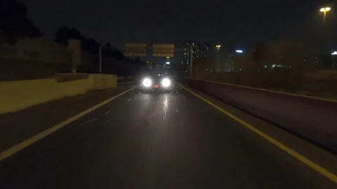POV driving fast reverse shot at night on dark highway with car traffic Видео 146926567