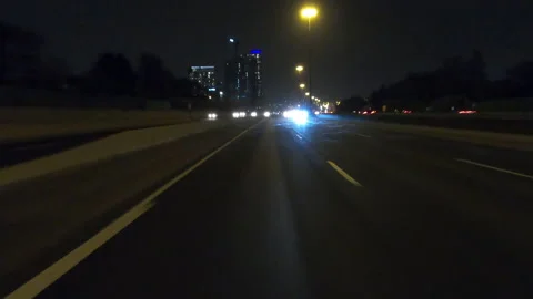 POV driving fast reverse shot at night on dark highway with car traffic Stockbeeldmateriaal 146927341