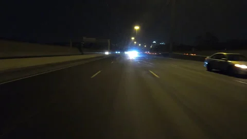 POV driving fast reverse shot at night on dark highway with car traffic Stock Footage 146927940