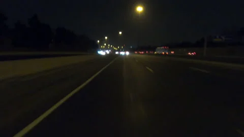 POV driving fast reverse shot at night on dark highway with car traffic Video stock 146928415