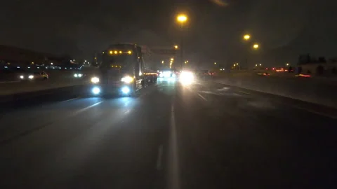POV driving fast reverse shot at night in the dark with car traffic Stock Footage 146929281