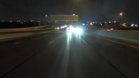 POV driving fast reverse shot at night in the dark with car traffic Stock Footage 146929872