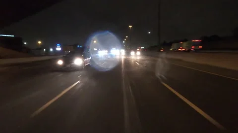 POV driving fast reverse shot at night in the dark with car traffic Stock Footage 146930237