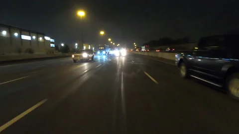 POV driving fast reverse shot at night in the dark with car traffic Видео 146930905