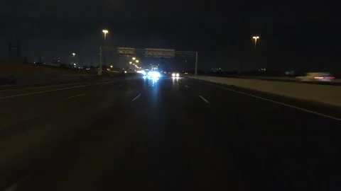 POV driving fast reverse shot at night in the dark with car traffic Video stock 146931094