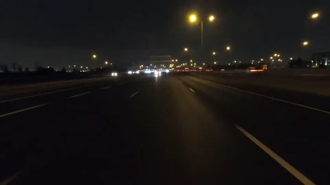 POV driving fast reverse shot at night on dark highway with car traffic Stock Footage 146931834