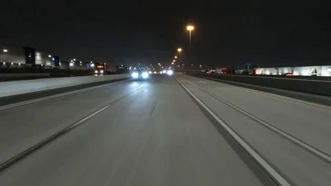 POV driving fast reverse shot at night on dark highway with car traffic Stockbeeldmateriaal 146932471