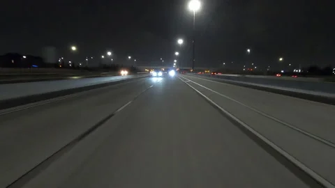 POV driving fast reverse shot at night on dark highway with car traffic Stock Footage 146932651