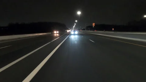 POV driving fast reverse shot at night on dark highway with car traffic Stock-Footage 146932771