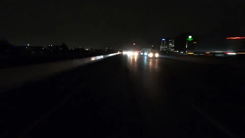 POV driving fast reverse shot at night on dark highway with car traffic Vídeo Stock 146933168