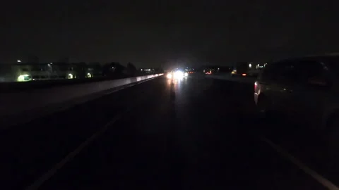 POV driving fast reverse shot at night on dark highway with car traffic Vídeos de archivo 146933310