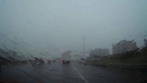 POV driving on highway in heavy traffic and torrential flooding rain storm Stock Footage