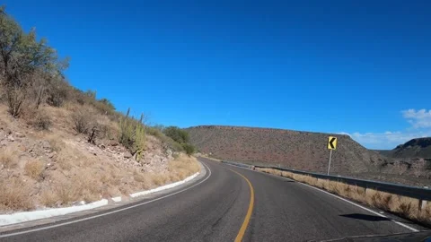 POV driving on highway running between mountain ranges of Baja California Sur Video stock 242765995