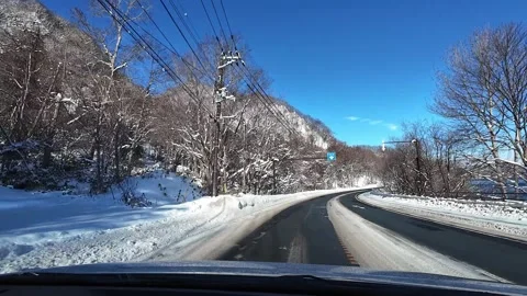 POV Driving at Intersection with Snowy Mountains View Hokkaido Japan Video stock 332938593
