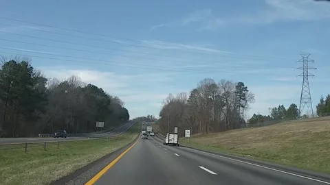 POV driving interstate 26 West with blue skys trees and traffic 1 Stock Footage 149579690