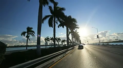 P.O.V. driving Miami city causeway at sunset, Florida, USA Stock Footage