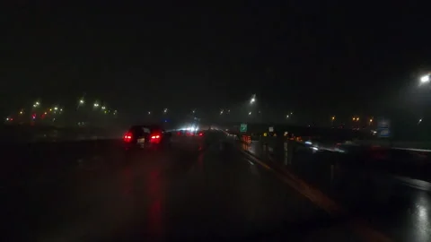 POV driving on a pitch back dark wet rainy night in the city streets Vídeo Stock 156745140