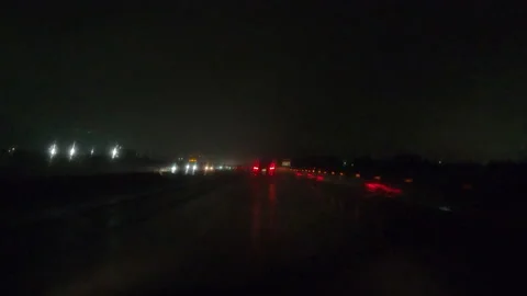 POV driving on a pitch back dark wet rainy night in the city streets 動画素材 156750535