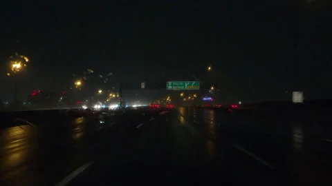 POV driving on a pitch back dark wet rainy night in the city streets Stock Footage 156760774