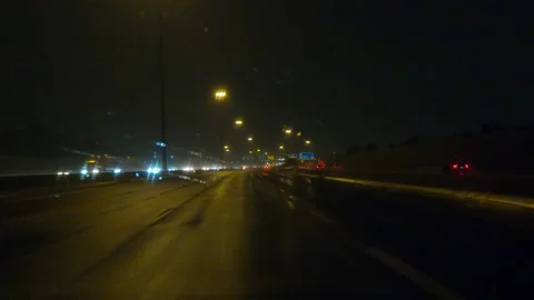 POV driving on a pitch back dark wet rainy night in the city streets Stock Footage 156762787