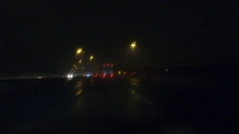 POV driving on a pitch back dark wet rainy night in the city streets Vídeo Stock 156764979