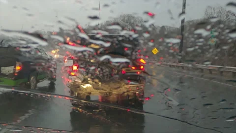 POV driving plate in heavy rush hour highway traffic in the rain Stock Footage 150406290