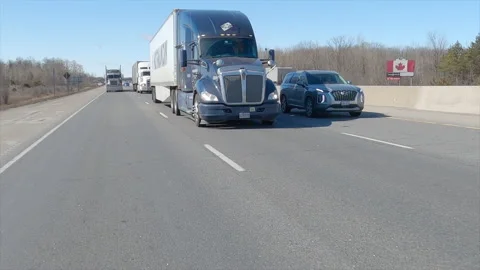 POV driving plate reverse shot tractor trailer trucks driving on highway Видео 149897882